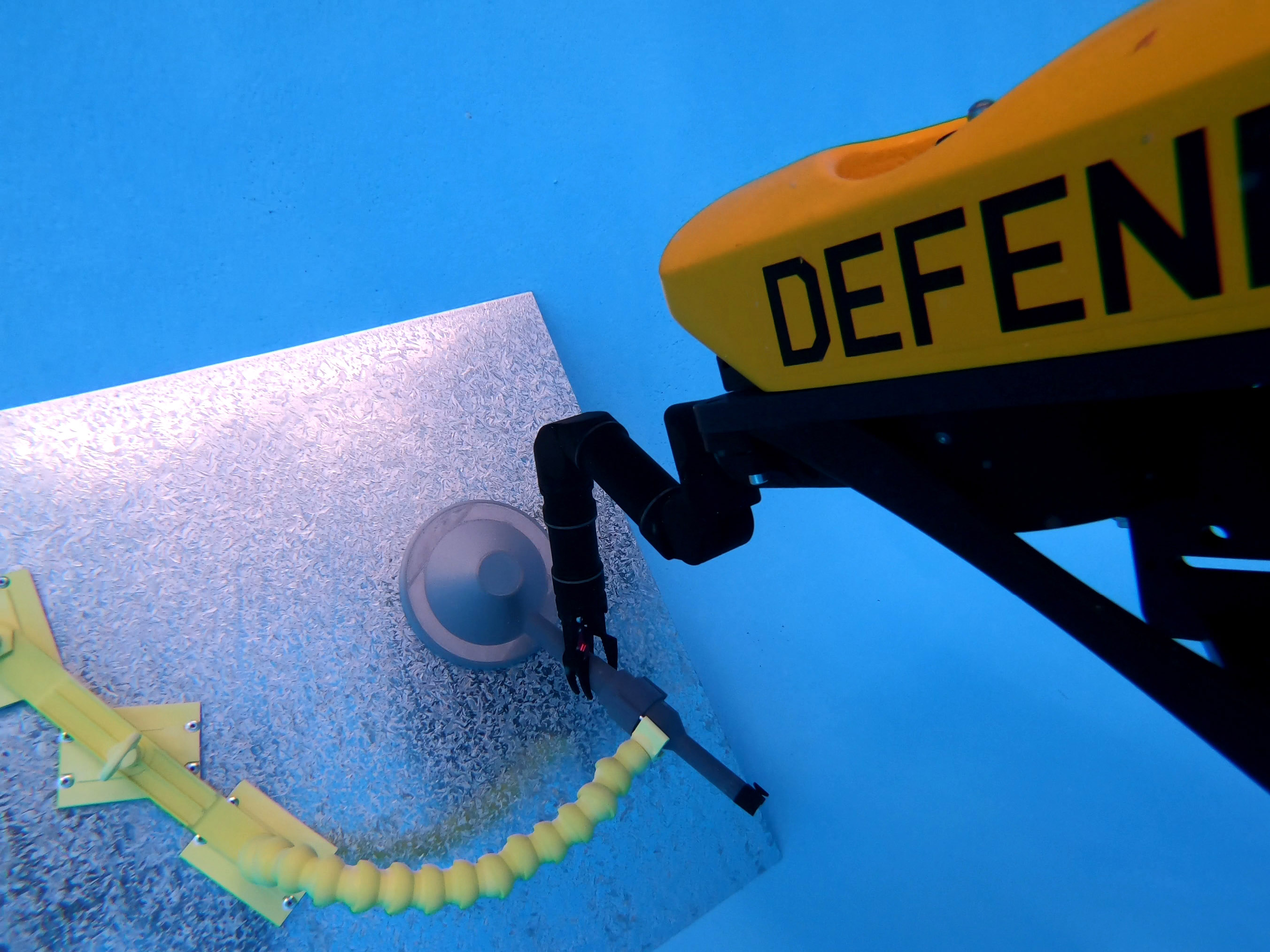 A VideoRay MSS Defender equipped with Blueprint Lab Reach 5 Mini underwater robotic arm carries out intervention trials